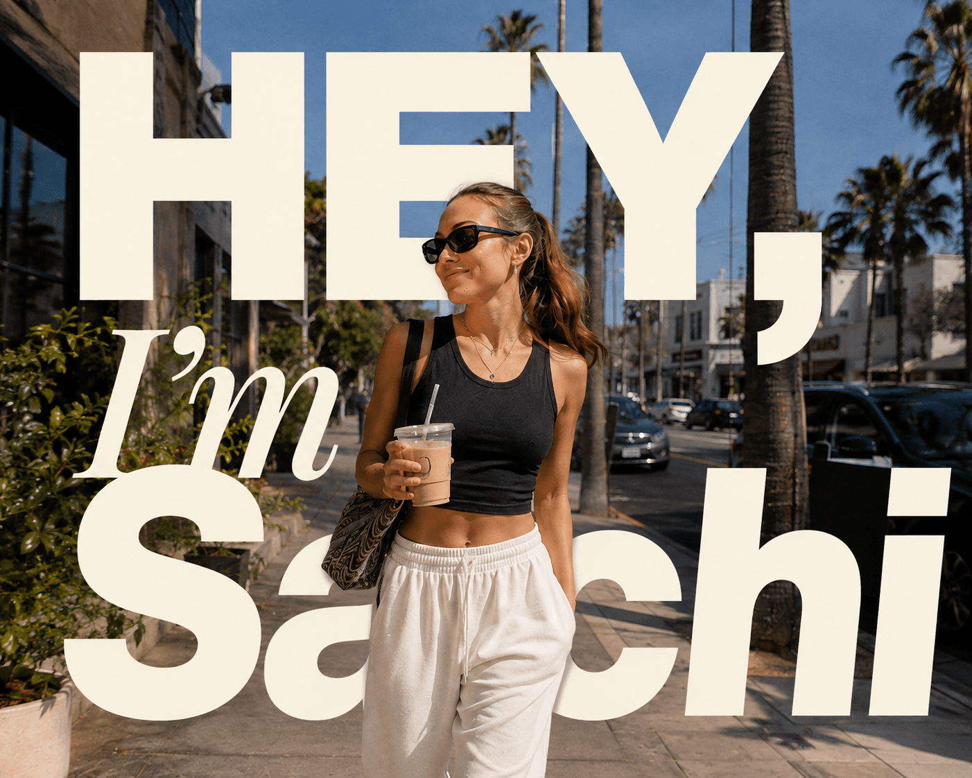 Sachi walking outside with an iced coffee